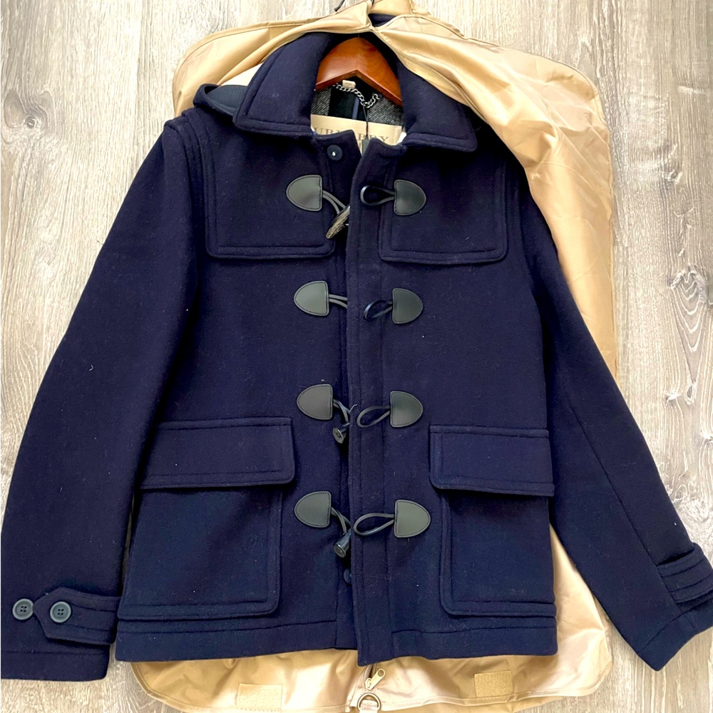 A duffle coat in a wool blend , woven with a Burberry Check interior . Size S